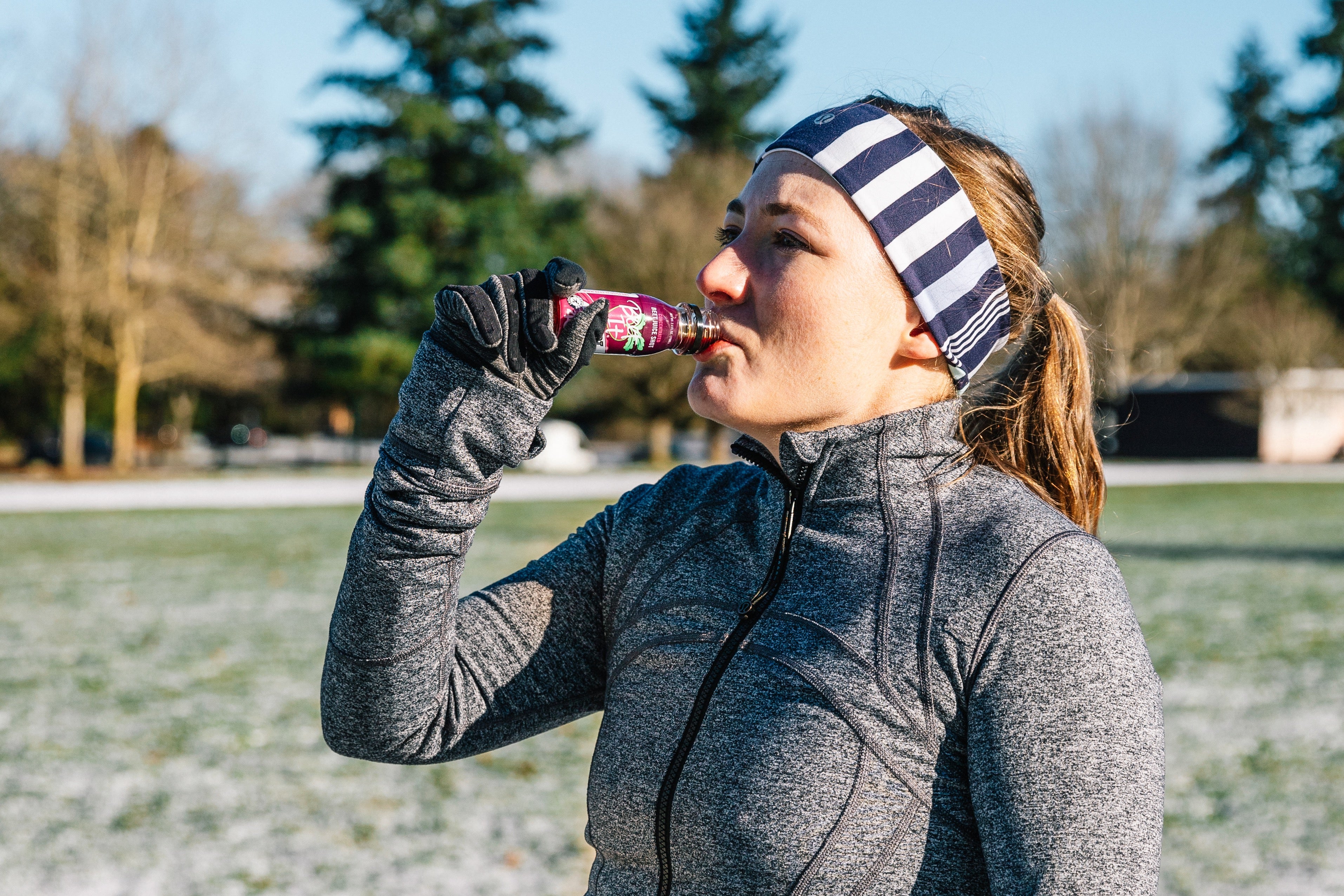 Runner drinking a Beet-It Sport shot after training