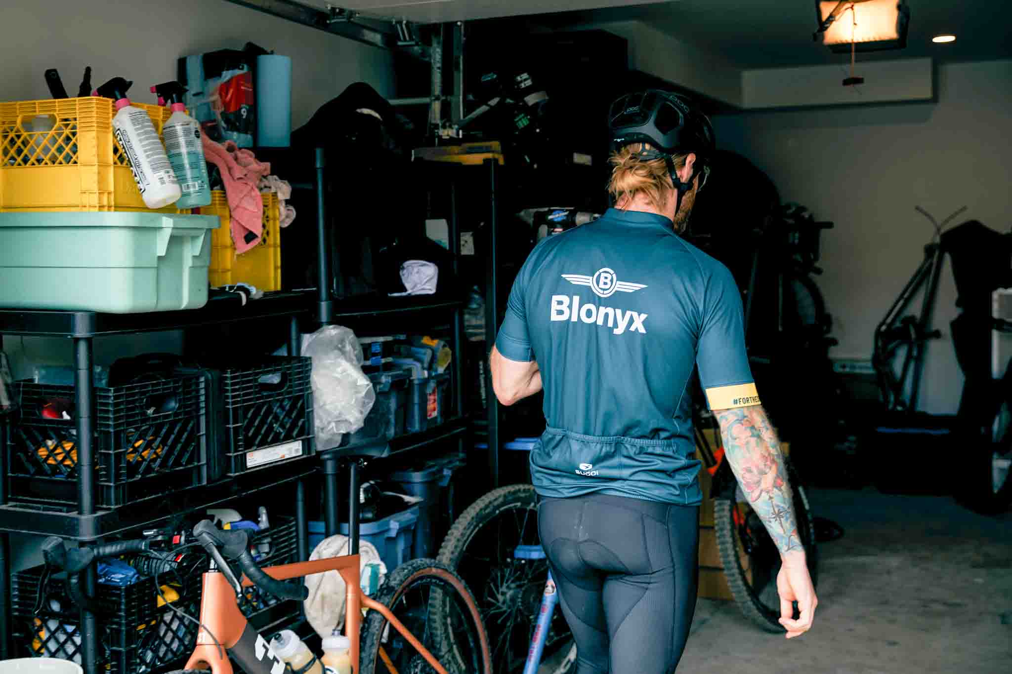 Mountain biker walking into their garage