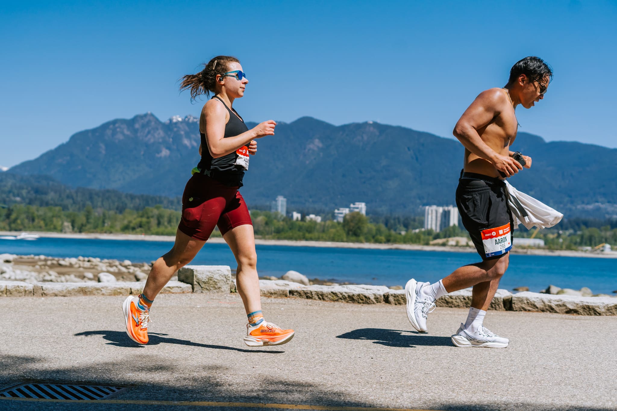 A male and female runner on the Vancouver Seawall during a Marathon