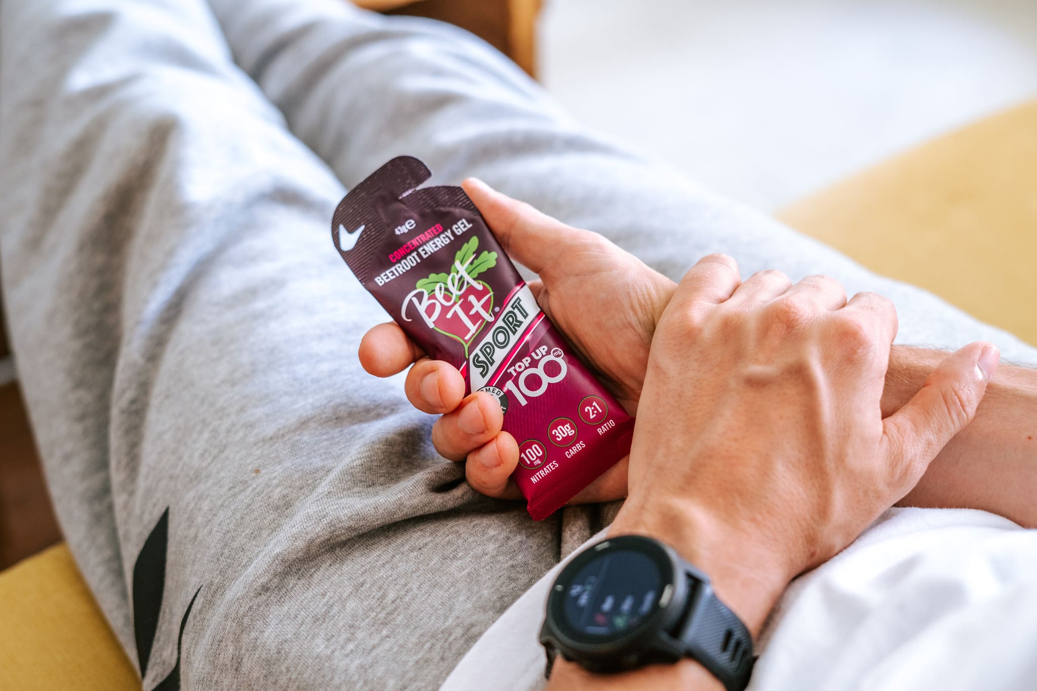 Someone Holding a Beet It Sport Top Up 100 Gel while Resting
