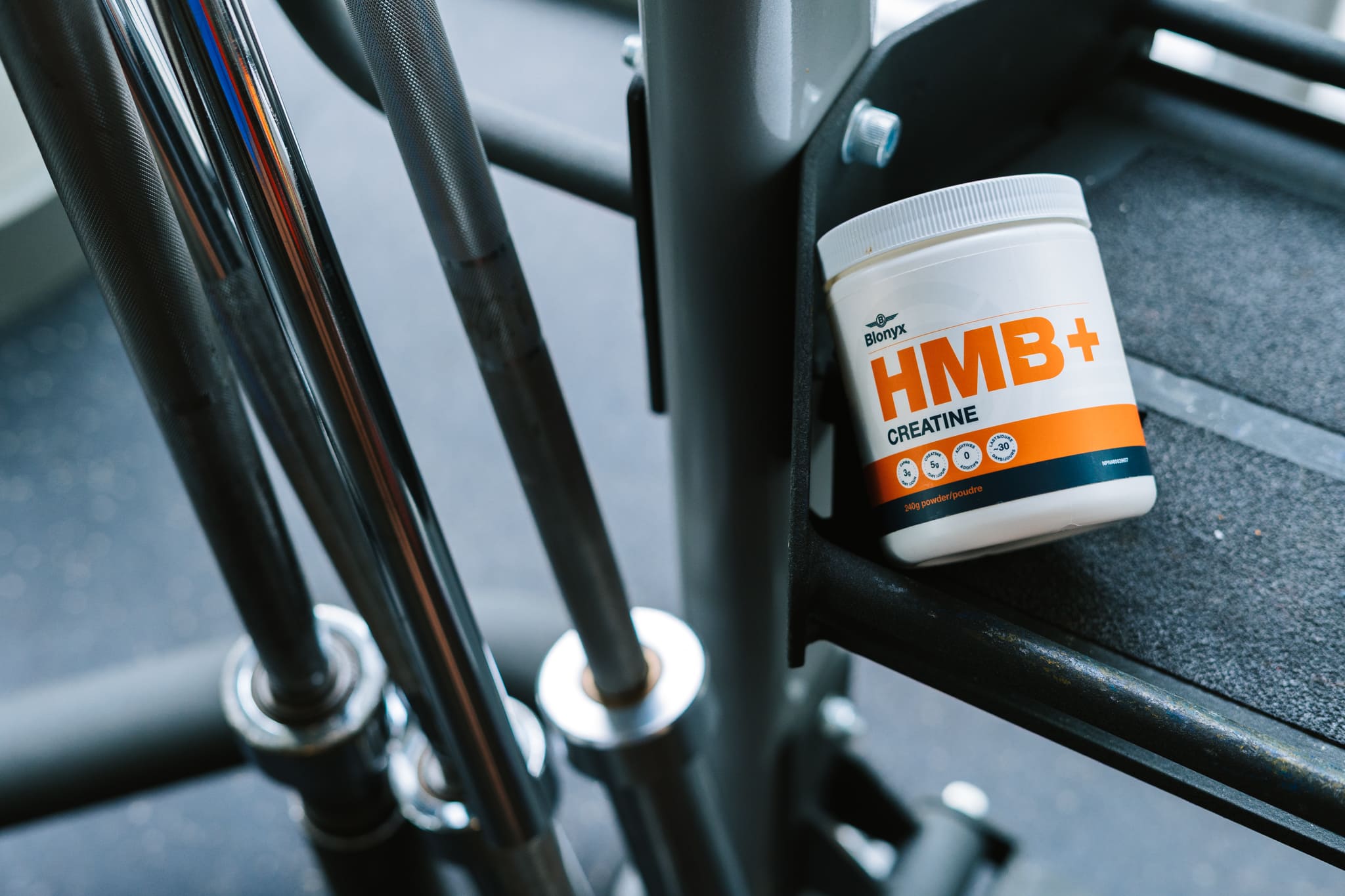 Blonyx HMB+ Creatine in a Gym next to Barbells