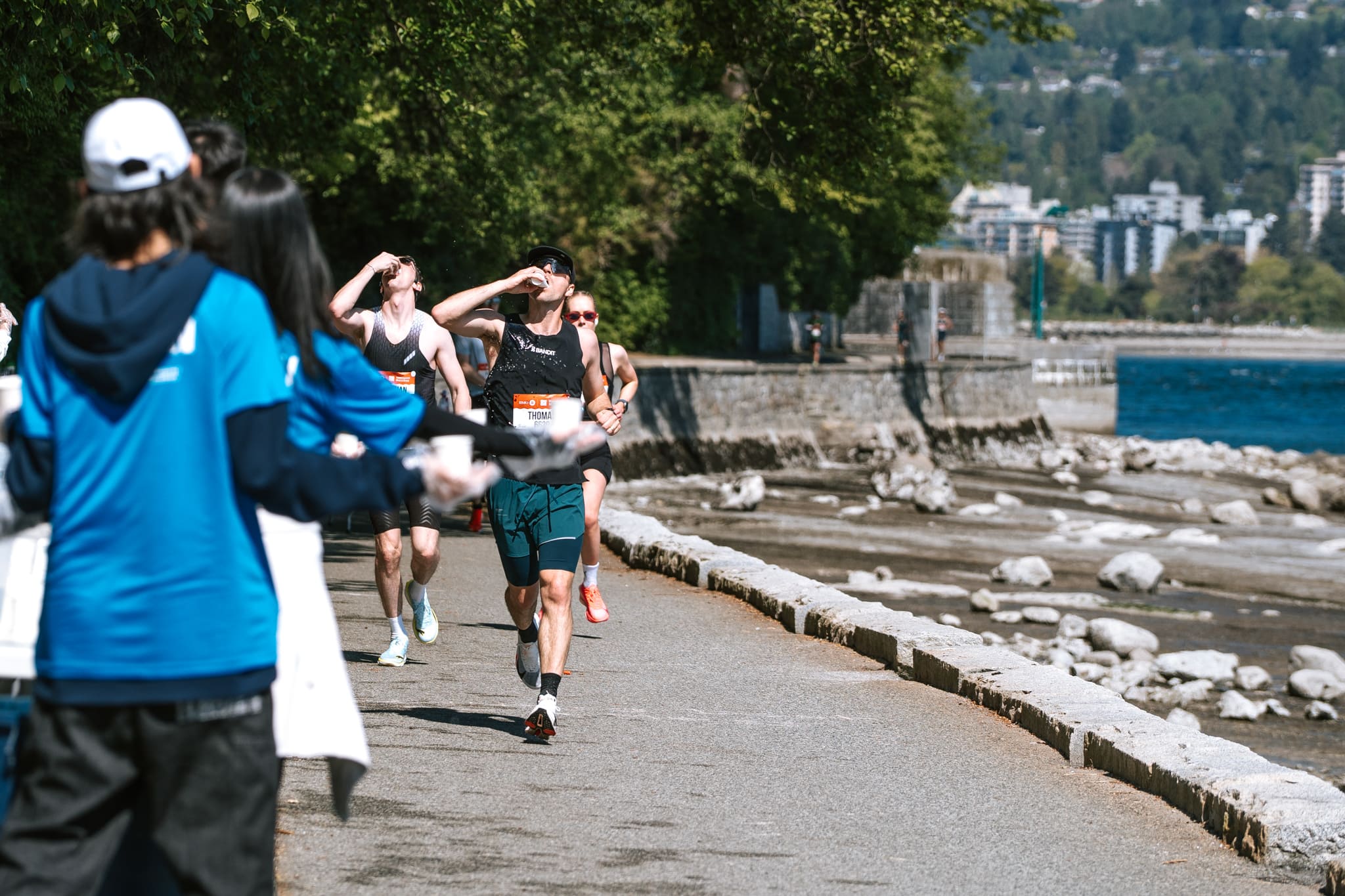 athletes in a marathon drinking