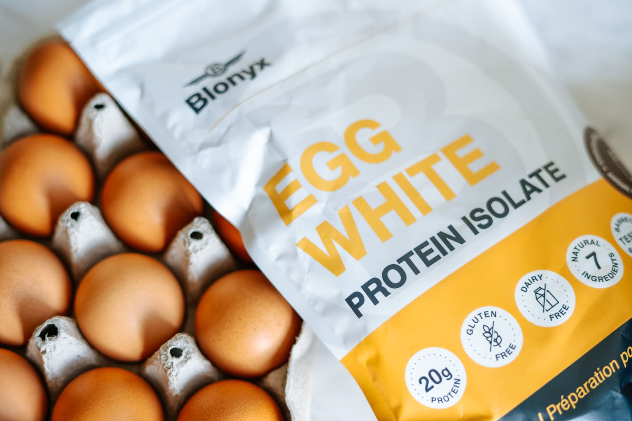 Blonyx Egg White Protein Isolate and a Carton of Eggs