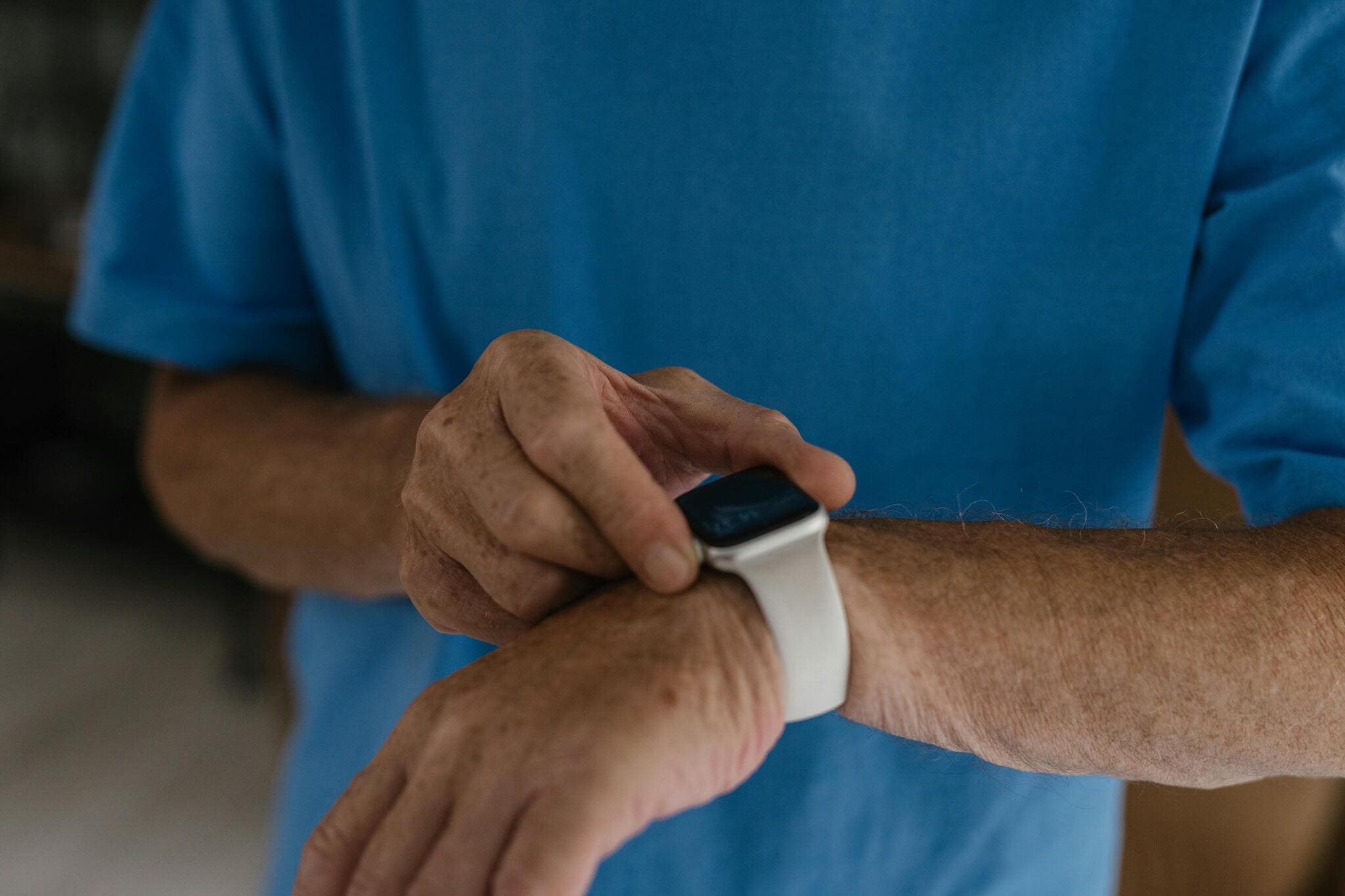 Close up of an athlete looking at his smartwatch to check his activity stats