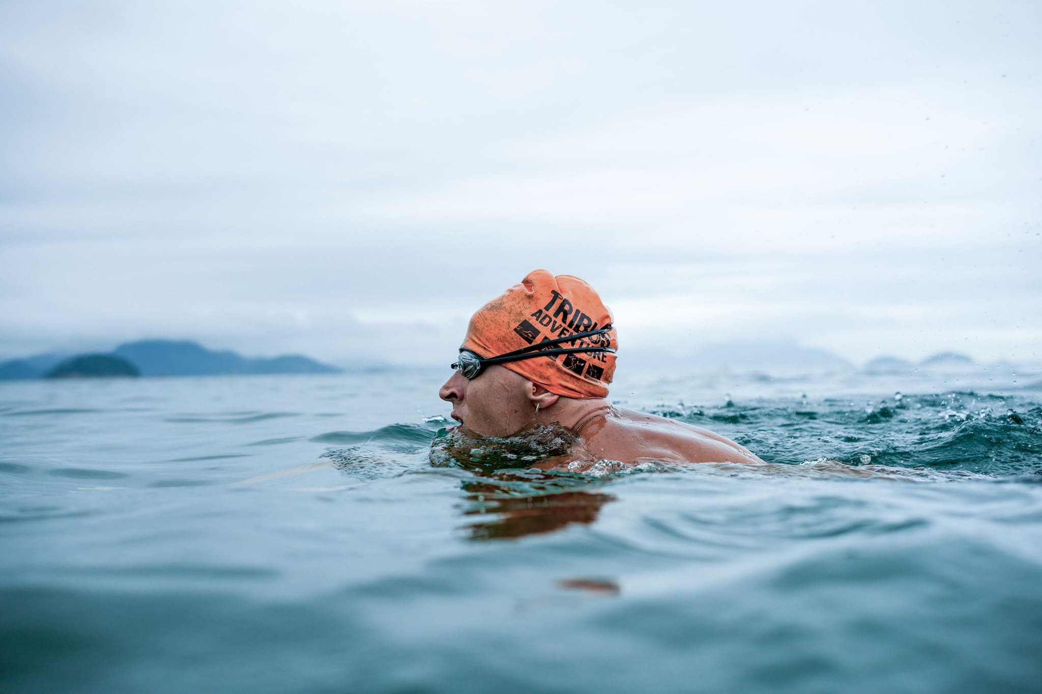 Open water swimmer in an orange swim cap