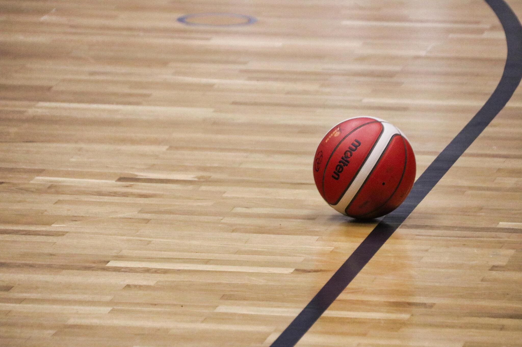 A basketball in the middle of an indoor court