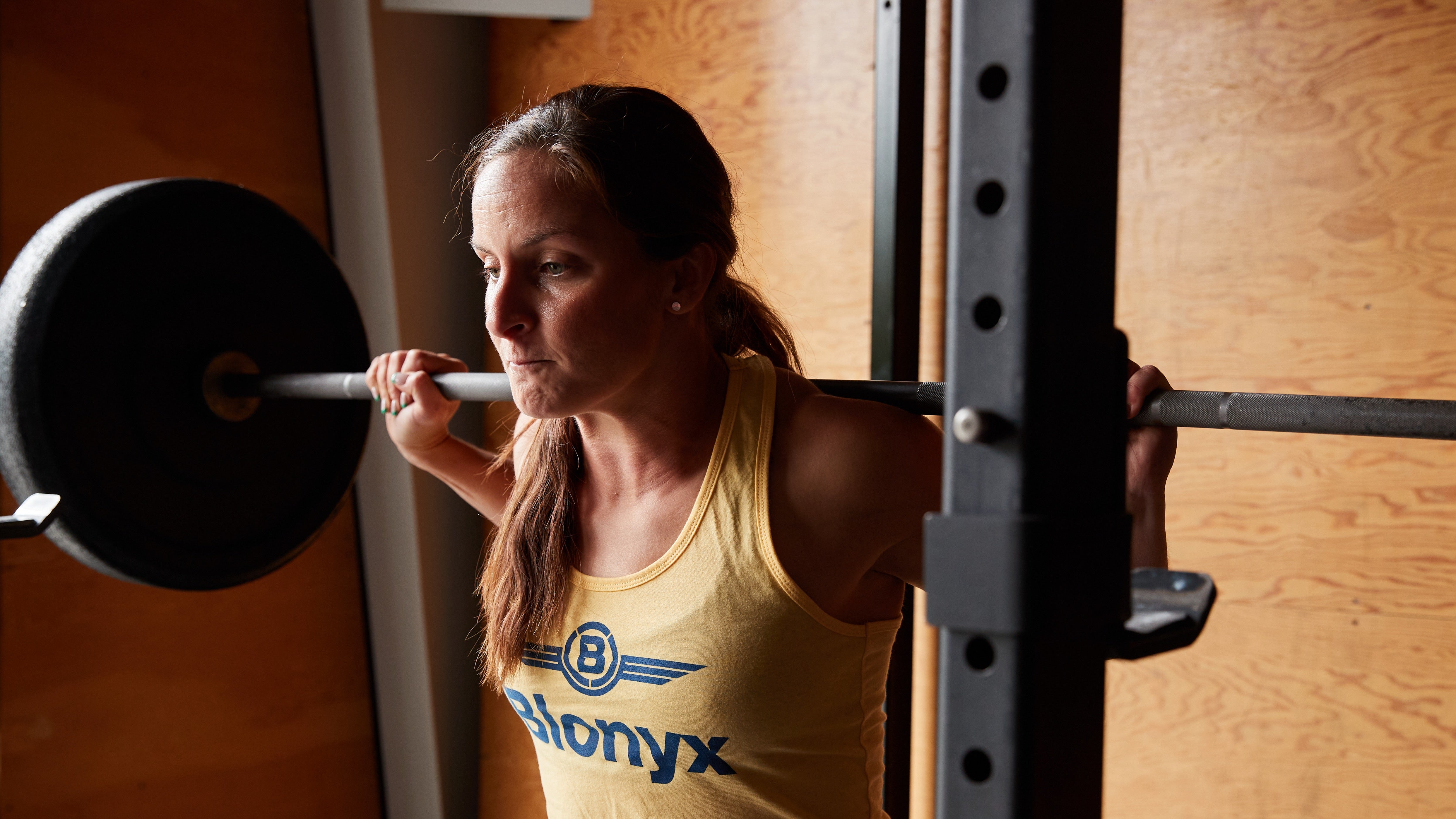 A CrossFit athlete performing squats.