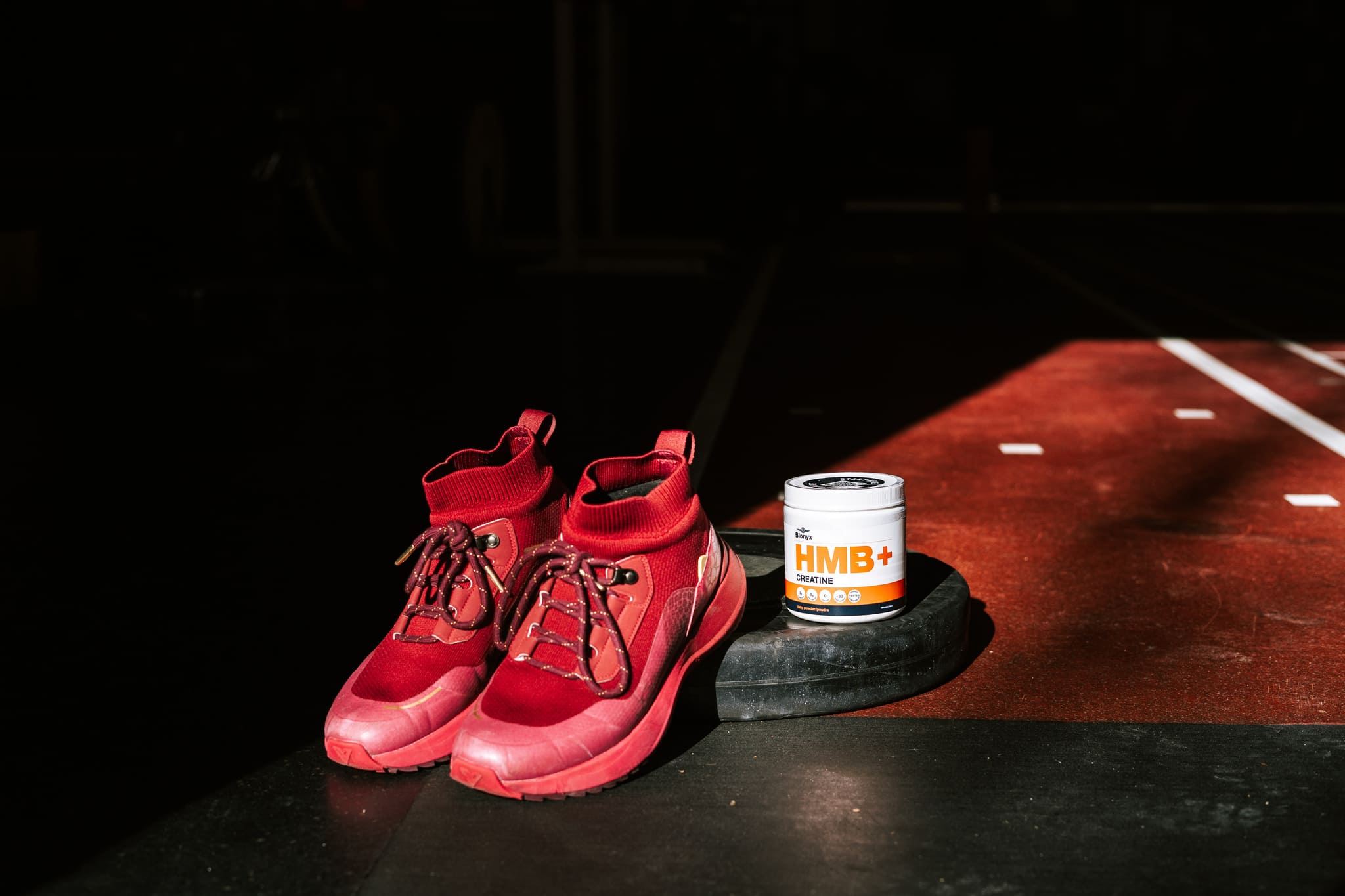 Blonyx HMB+ Creatine and a Pair of Power Lifting Shoes on a Weightplate