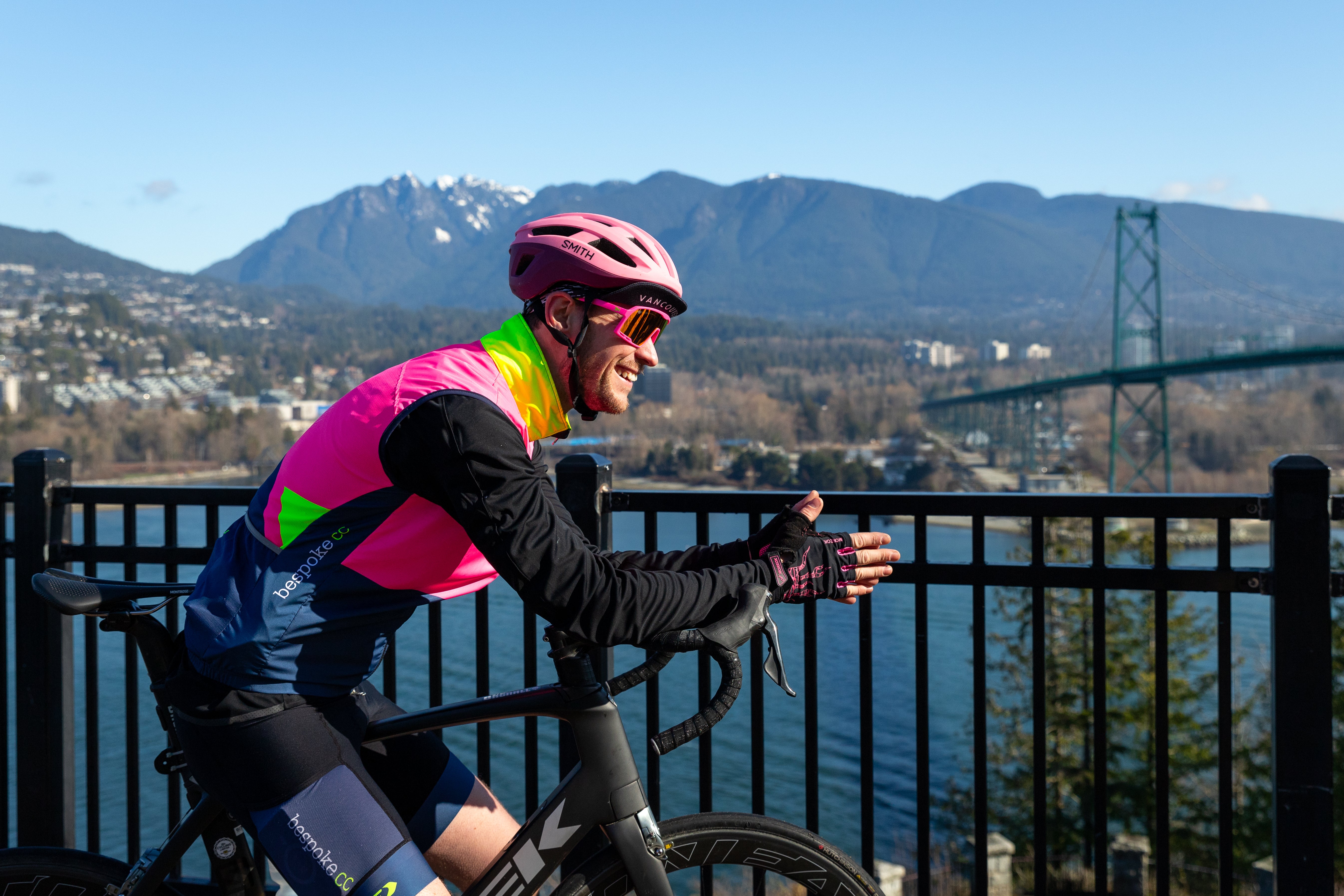 Cyclist looking out over the Lions Gate Bridge in Vancouver