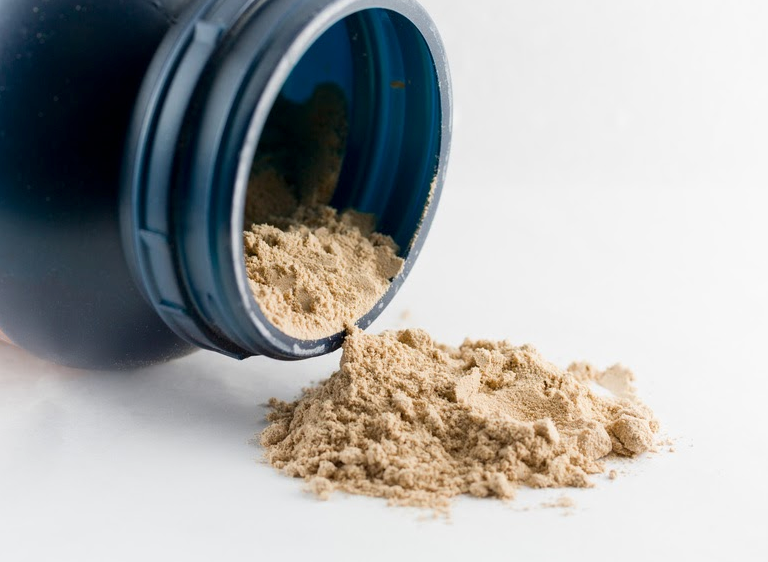 Protein powder spilling from a jar