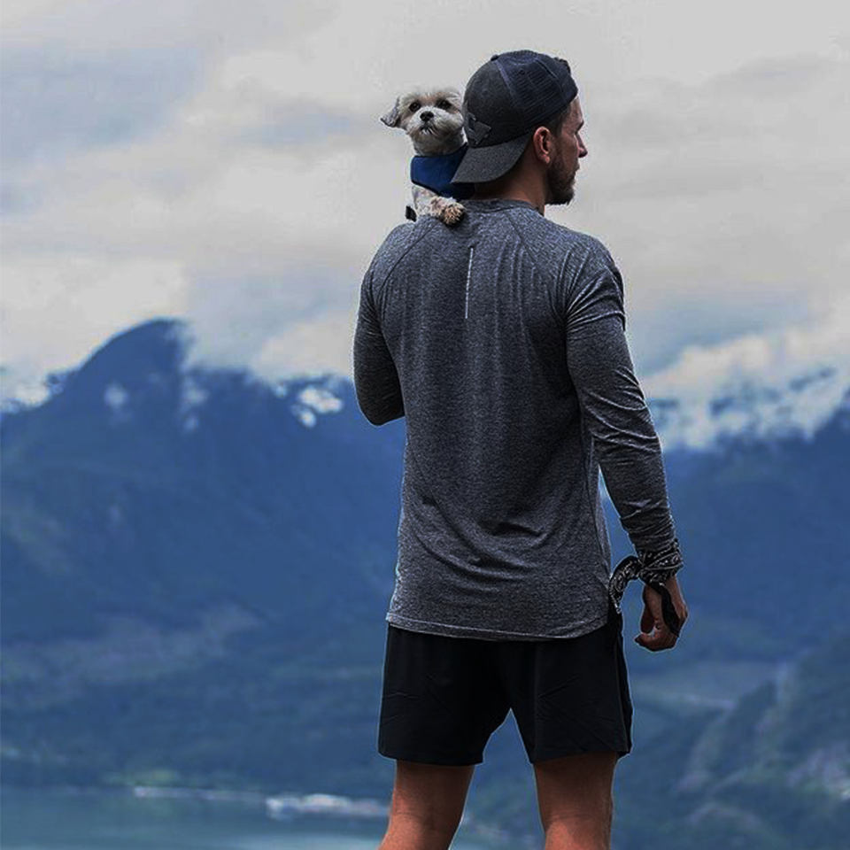 Vancouver athlete holding dog on a mountain