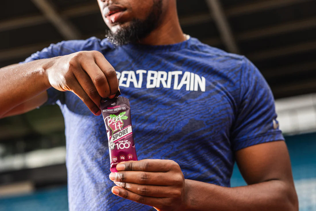 Athlete opening a Beet It Sport Top Up 100 Energy Gel