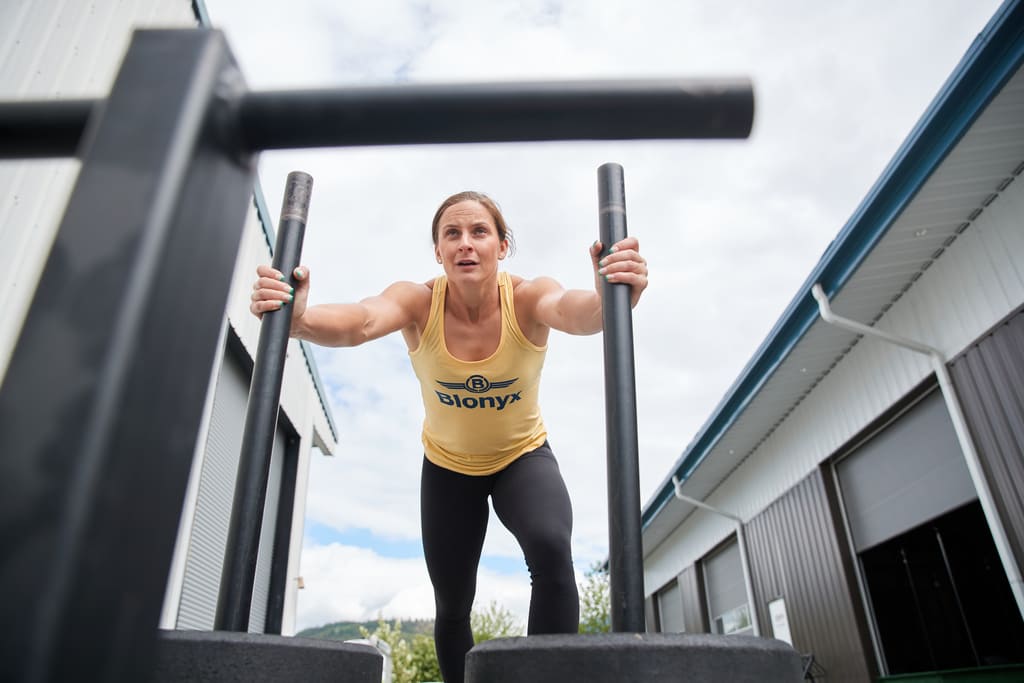 A CrossFit athlete pushing a sled.