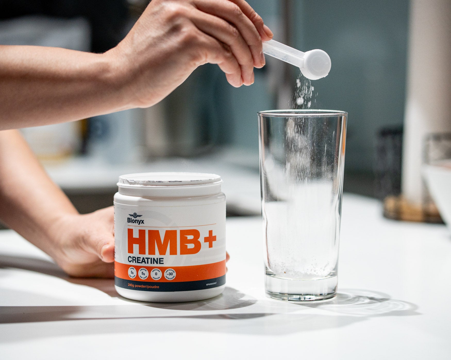 Athlete scooping Blonyx HMB+ Creatine