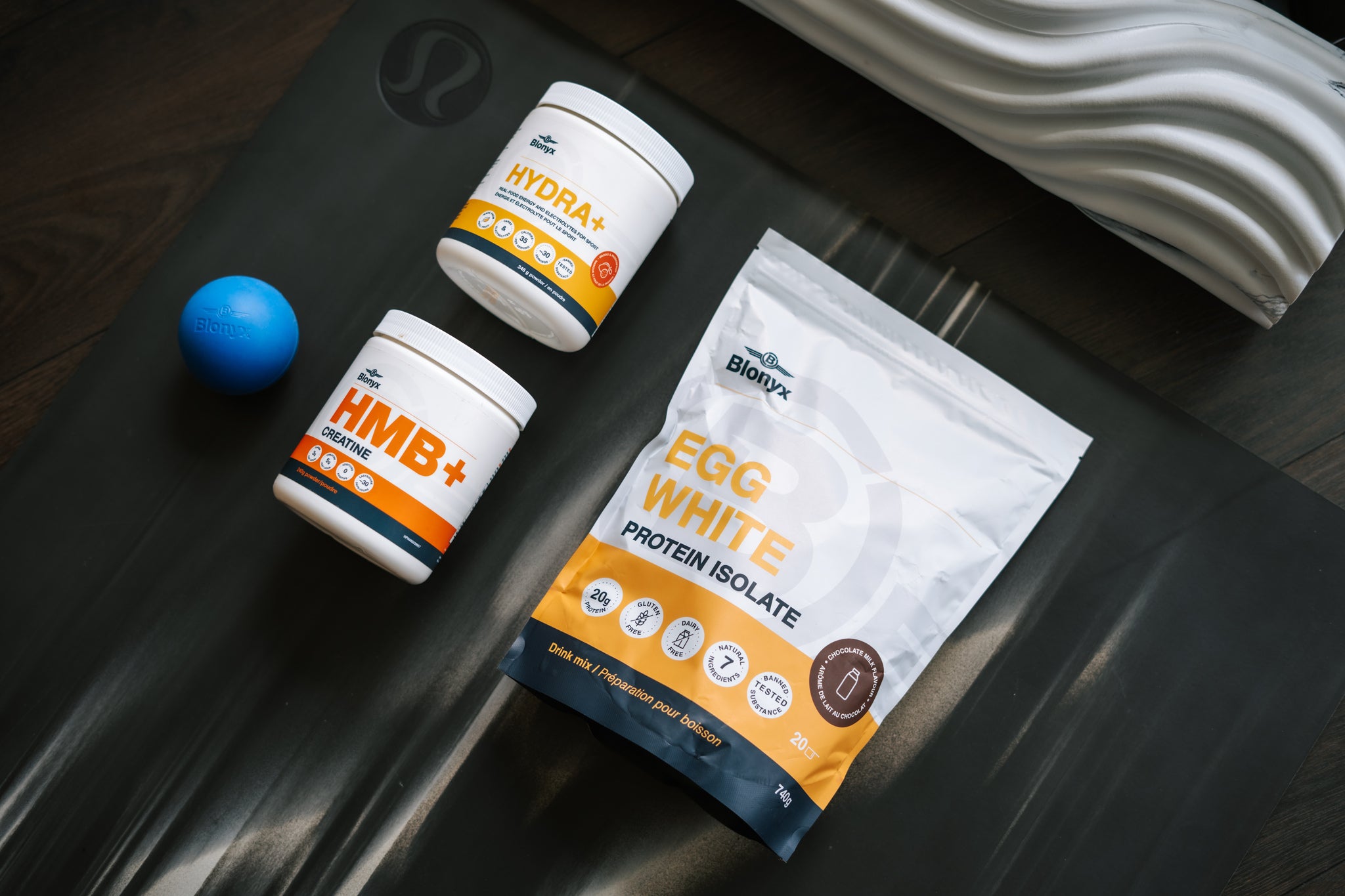 Three Blonyx products on a yoga mat