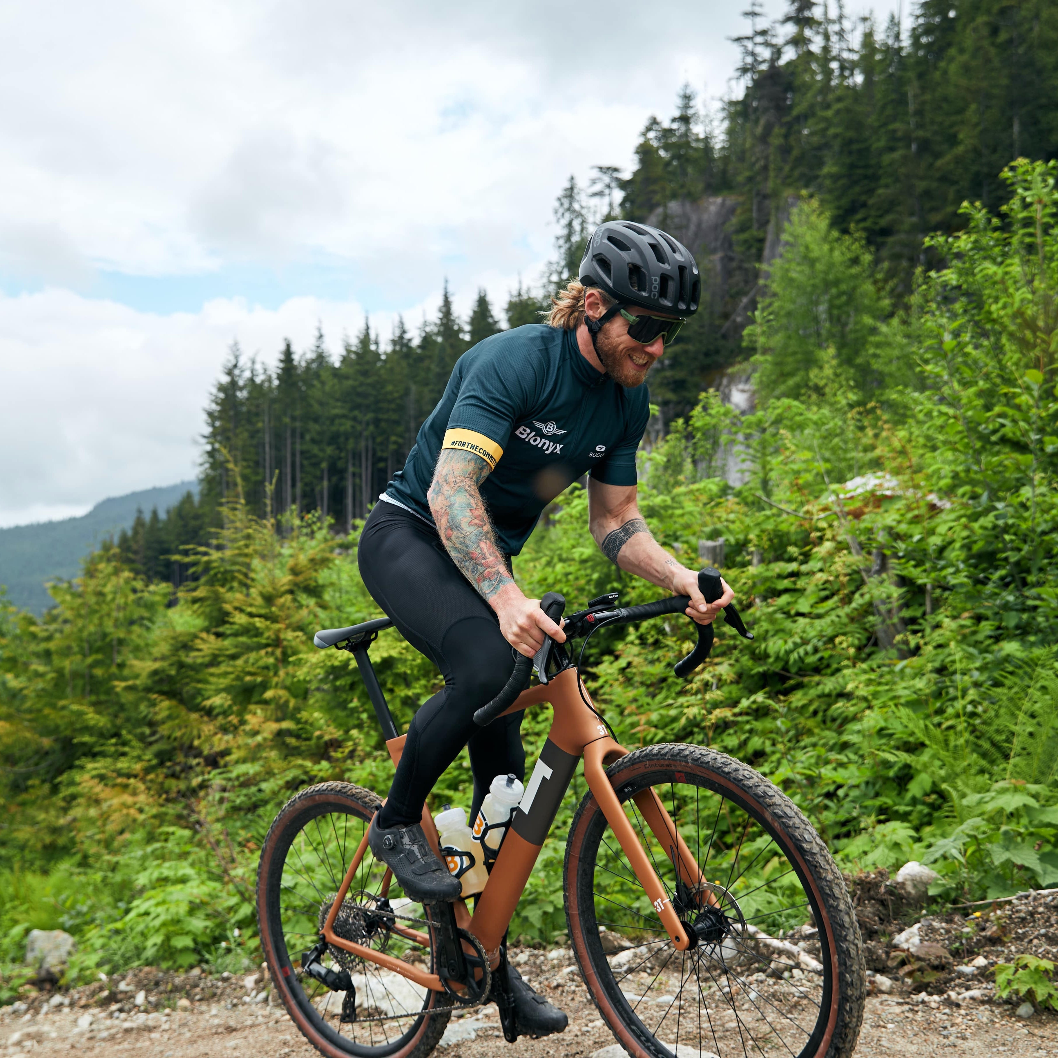 Mountain biker peddling up a steep gravel trail