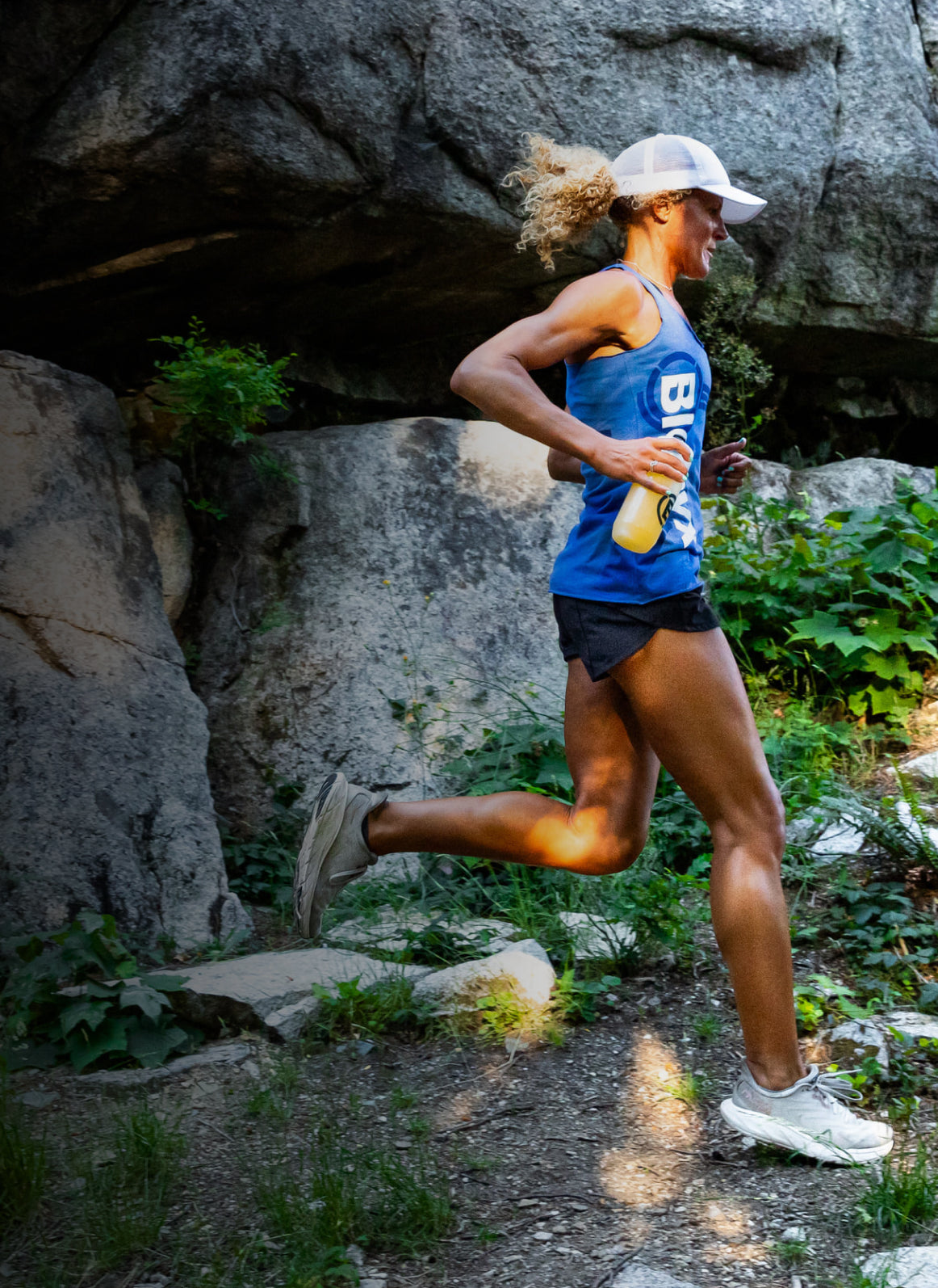 Trail runner moving along a rocky cliffside