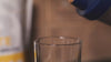 Pouring Blonyx Egg White Protein Isolate from a shaker cup into a glass
